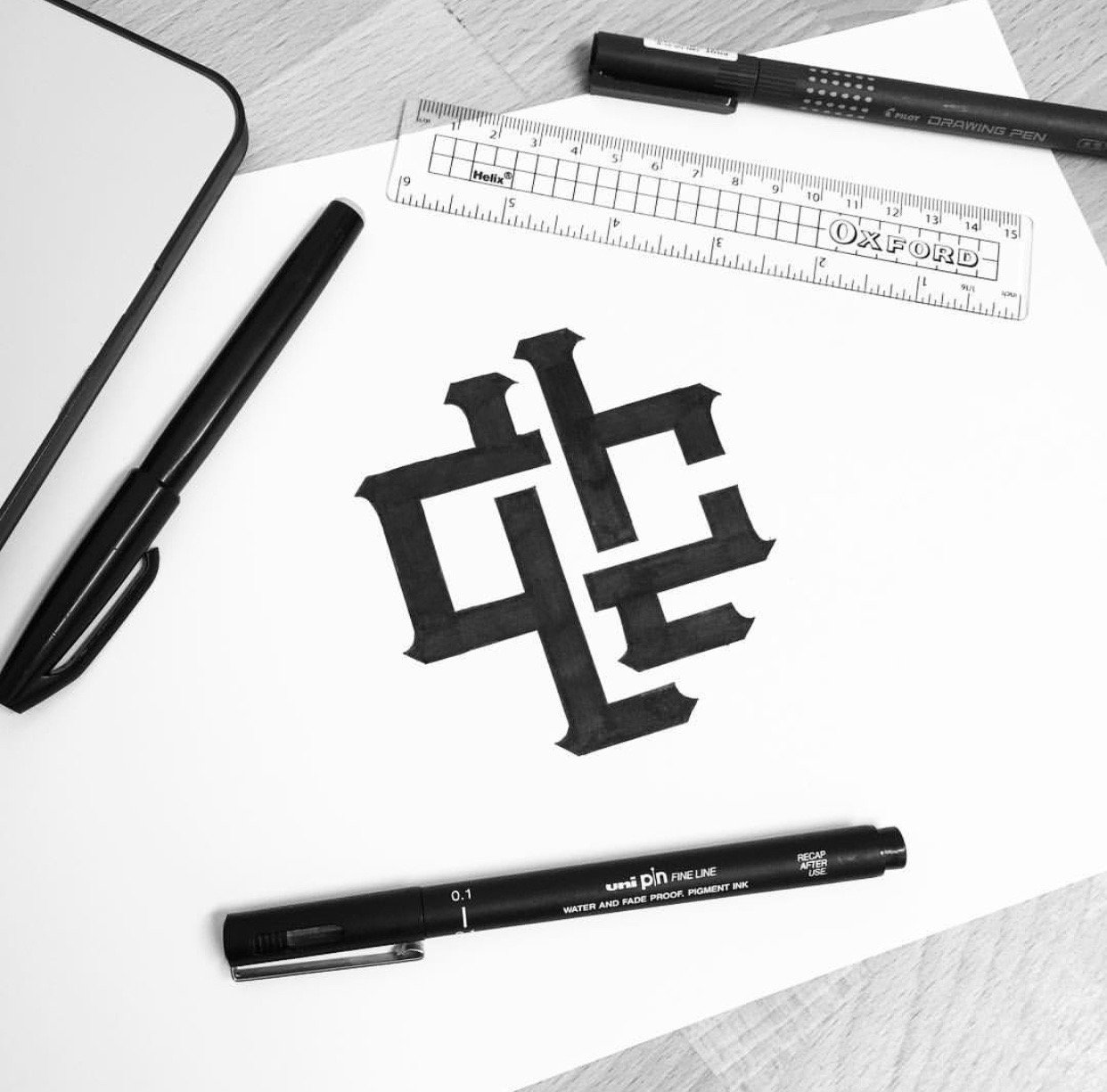 Monogram, design and lettering with pens and tools around