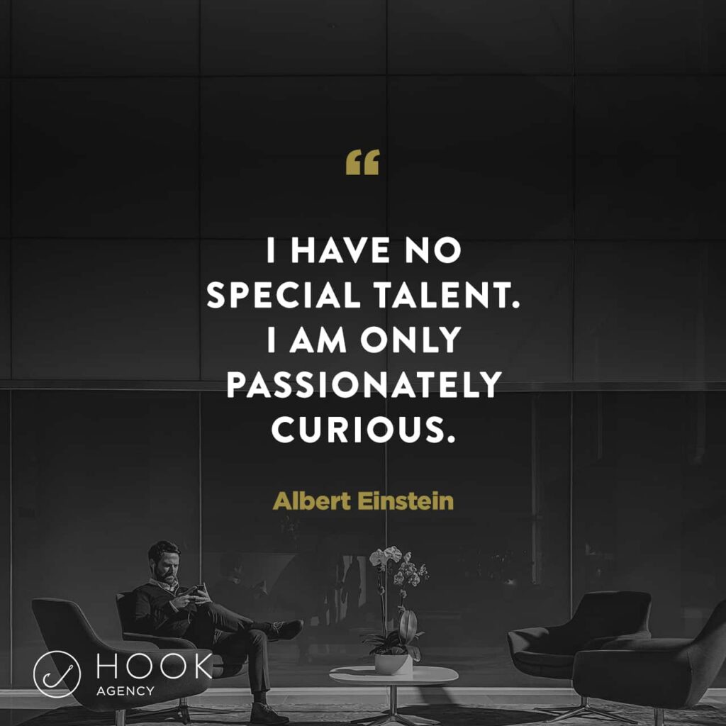 A man in a contemporary lobby, accompanied by two chairs