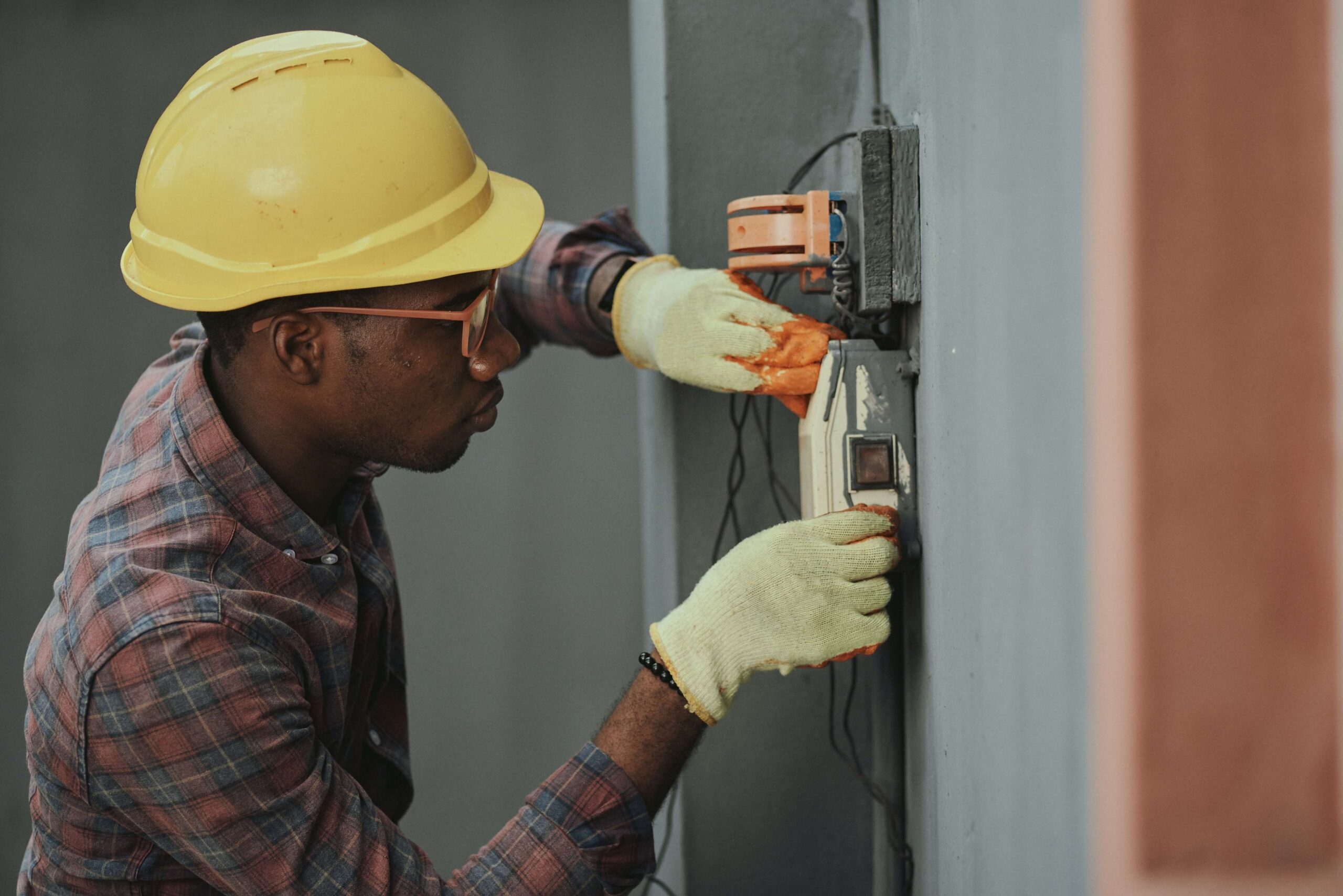 a commercial electrician fixinng an electrical equipment of a building