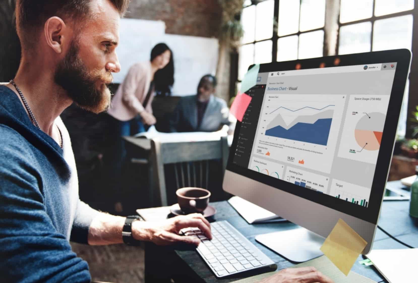 Hipster looking at chart - Featured image for 'Best Minneapolis SEO Companies'