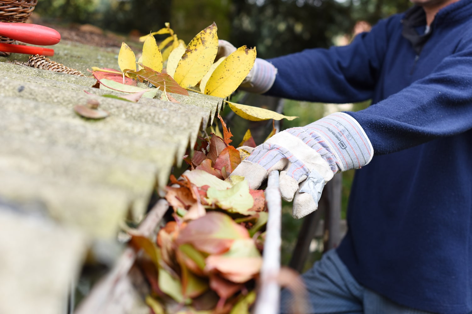 man cleaning out gutters to help get more google reviews