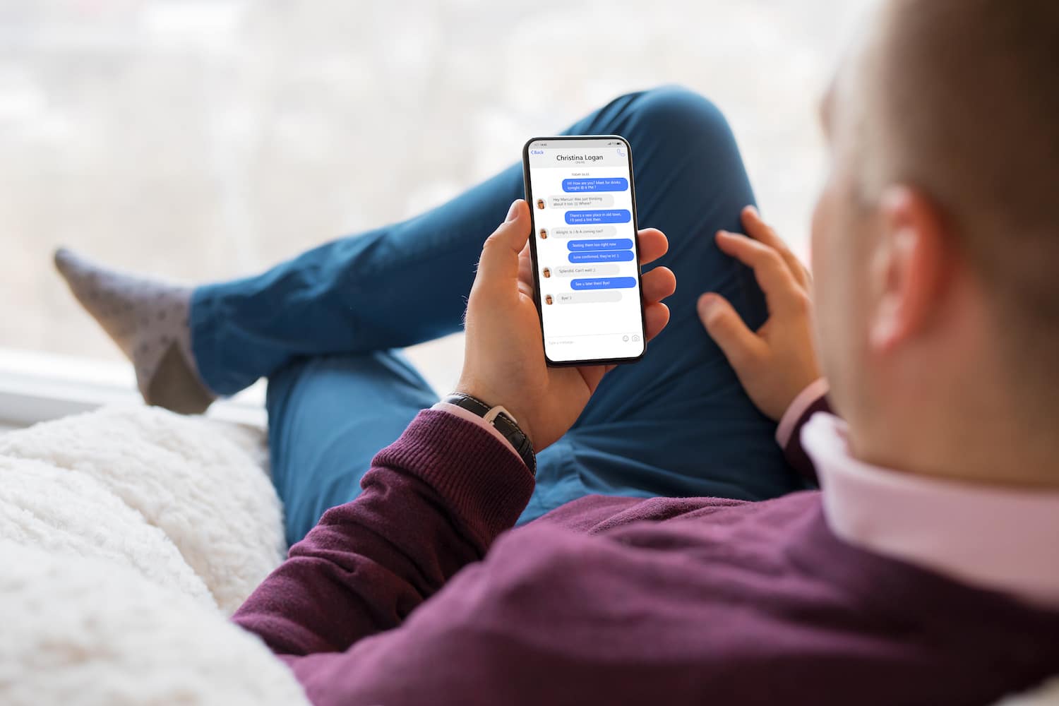 man sitting back and chatting with roofing company on Facebook Messenger