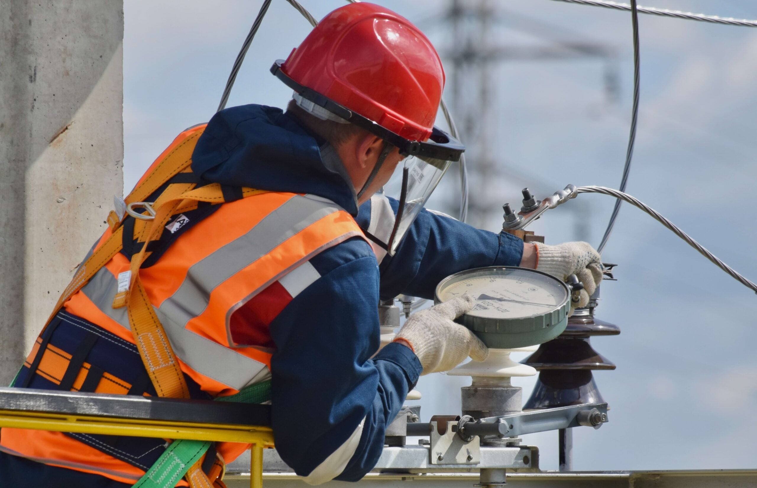 industrial electrician working on a transmission line