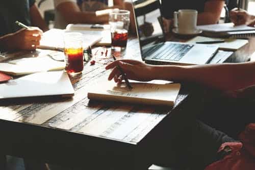 Team collaborating around a wooden table