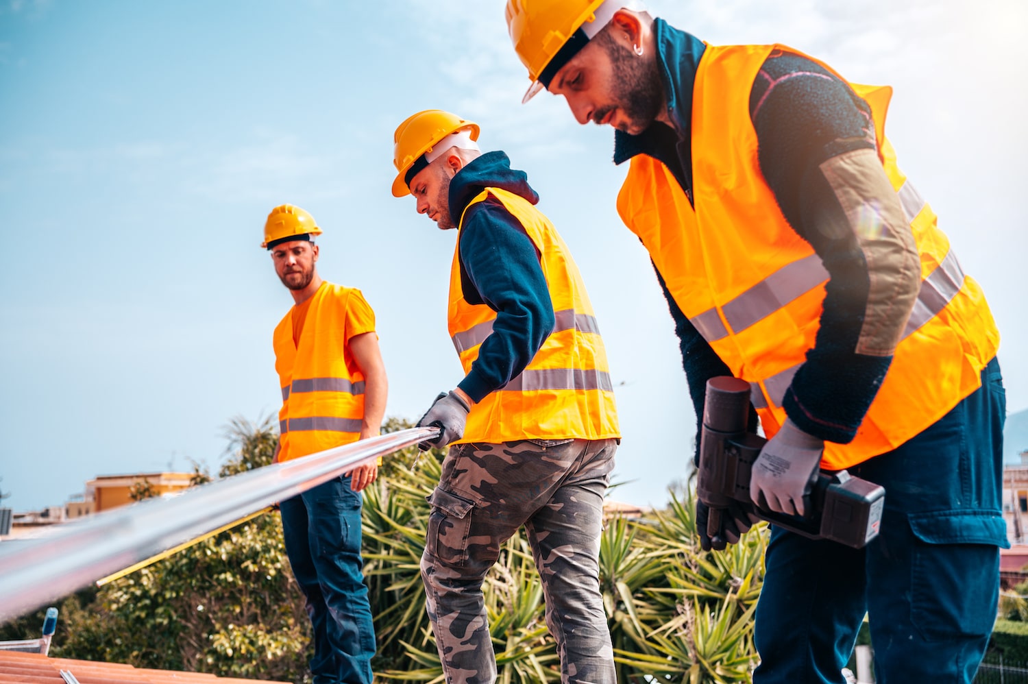 Team of technical workers work on the roof