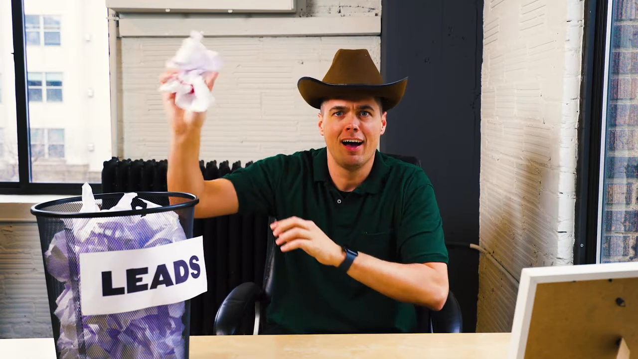 a man in a cowboy hat sits at a desk