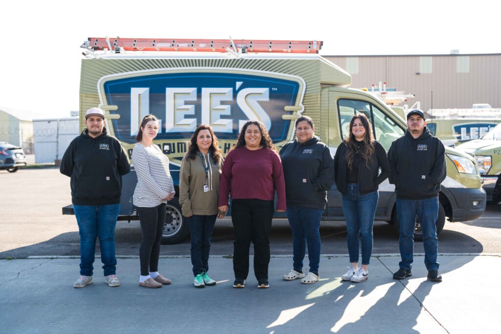 Seven members of the Lee’s Heating and Air Conditioning team stand in front of a branded company van, confident and ready to grow their HVAC business. Dressed in work uniforms and casual attire, they represent the dedication and professionalism behind Lee’s commitment to service.