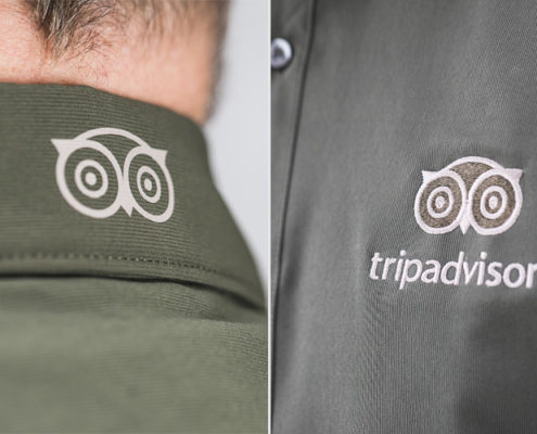 Green shirt with TripAdvisor owl logo on collar and "tripadvisor" on chest; ideal for home service business uniforms.