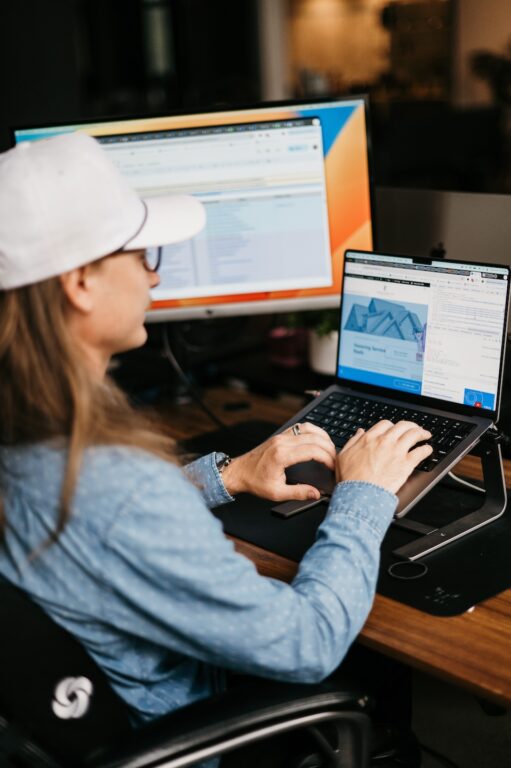 Professional optimizing HVAC Google Maps SEO at desk, reviewing spreadsheets on dual screens, typing in a focused office setting.