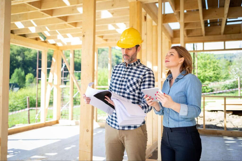 A contractor and client review documents onsite with the Contractor Follow-Up System, streamlining project progress tracking.