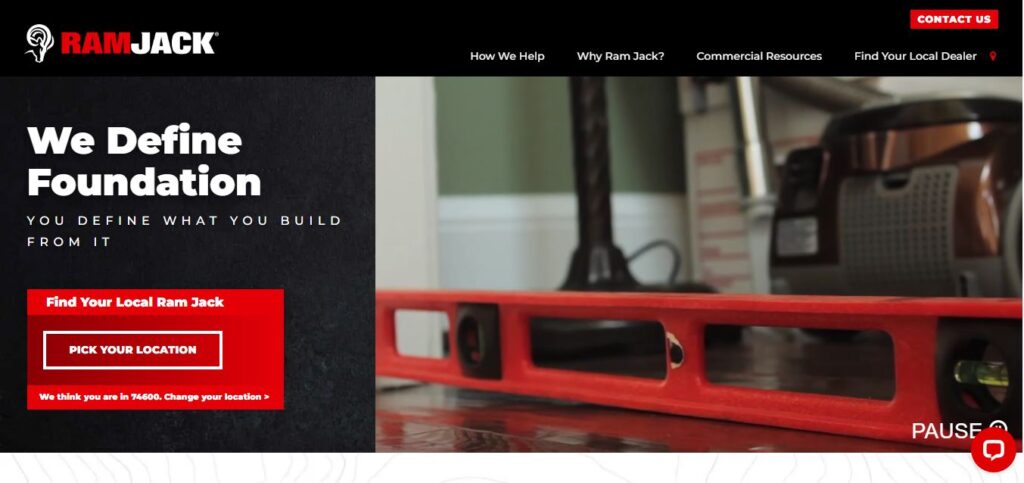 Ram Jack homepage with “We Define Foundation” text, red level tool, vacuum cleaner, and button to find your local dealer.