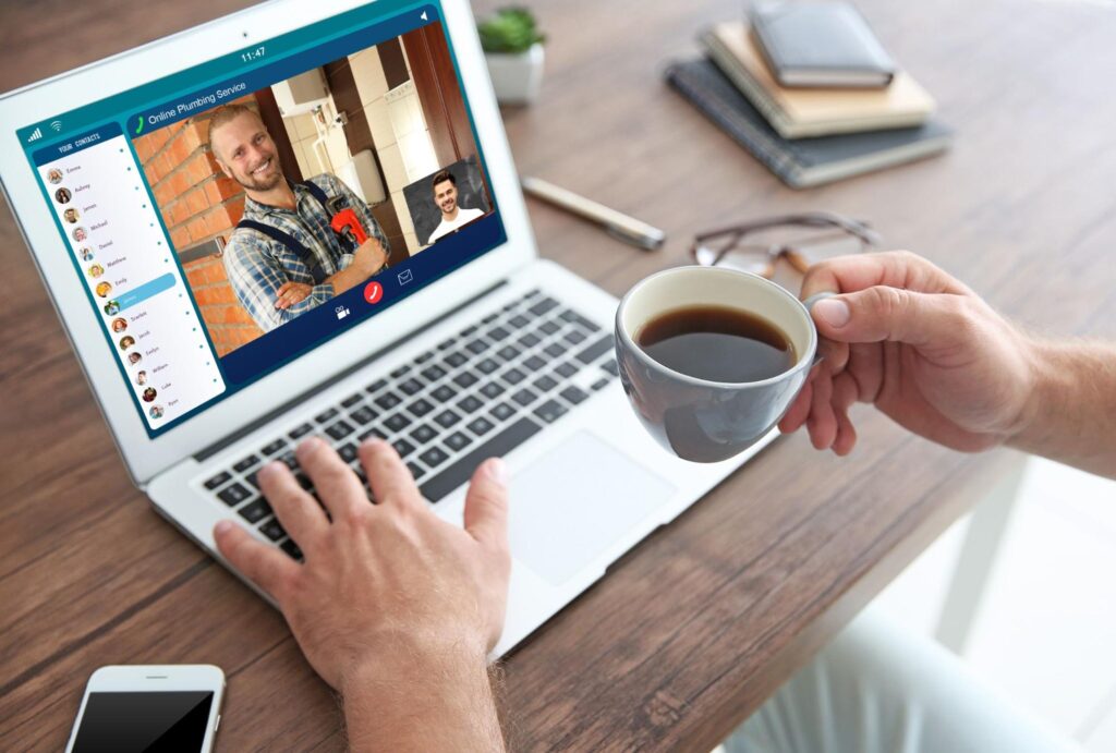 On a desk with a coffee cup, smartphone, glasses, and notebooks, a video call discusses home services lead quality for Hook Agency.