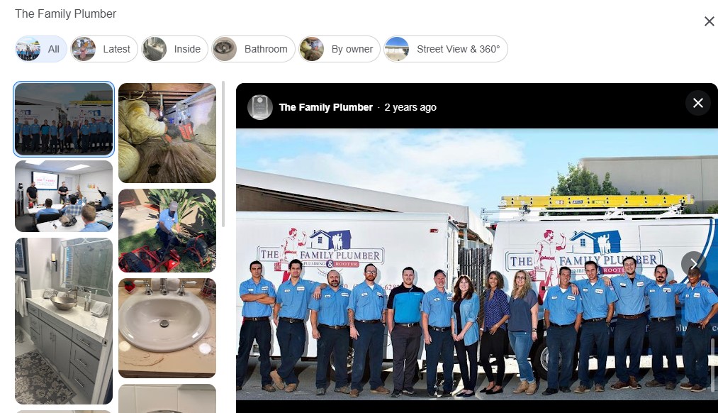 Eleven team members in blue uniforms pose by two "The Family Plumber" vans, highlighting a top home service client of Hook Agency.