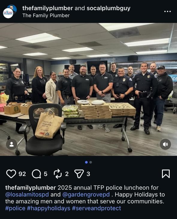 Plumbers and police officers smile behind a lunch table with pizza; Instagram holiday posts build trust for home service brands.