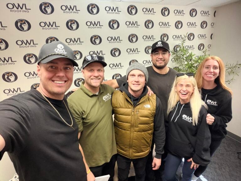 Six team members pose in front of an OWL Roofing backdrop, highlighting contractor motivation and consistency at Hook Agency.