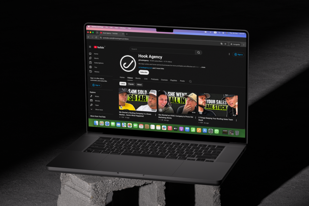 Laptop screen displaying the Hook Agency YouTube channel homepage with video thumbnails.